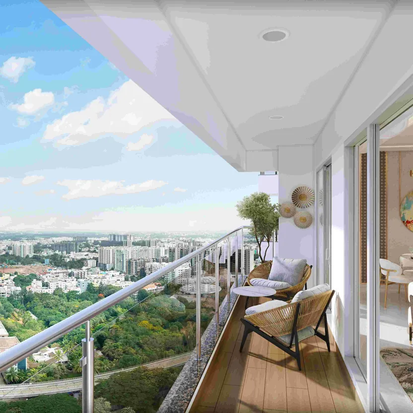 A living room opening onto a balcony with a city view