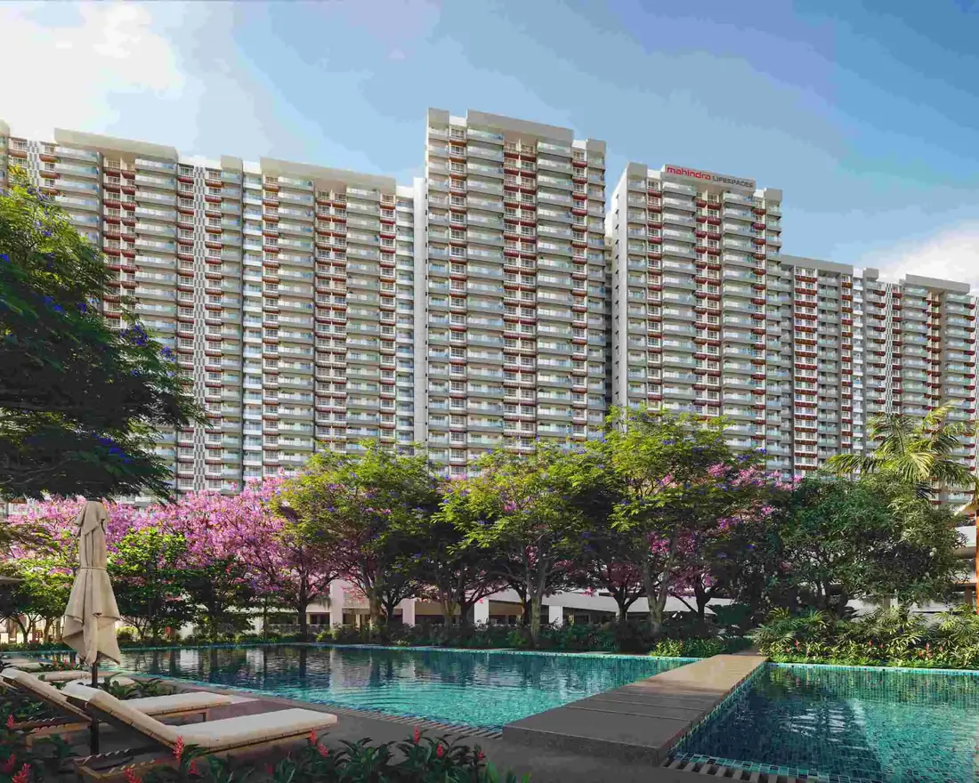 The Mahindra Blossom towers above a swimming pool and gardens of flowering trees